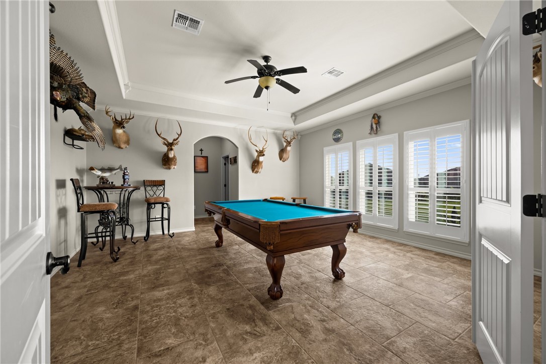 5310 Capernaum Court Corpus Christi, TX 78413 - Photo 12 of 40 a living room with furniture a pool table and a fireplace