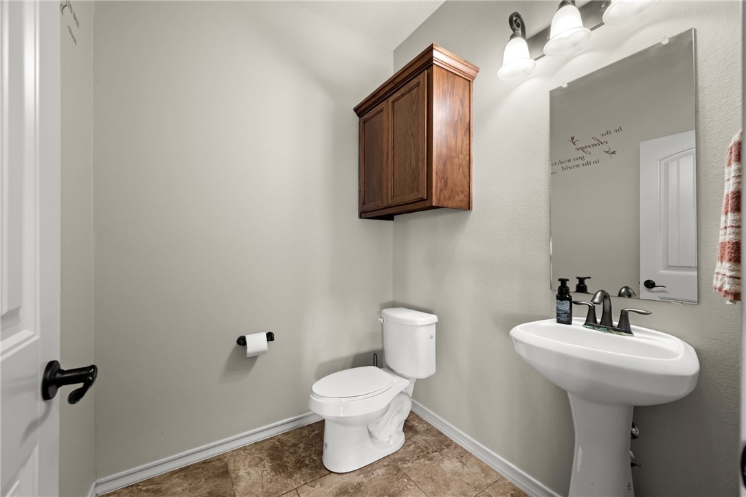 5310 Capernaum Court Corpus Christi, TX 78413 - Photo 14 of 40 a bathroom with a toilet sink and mirror