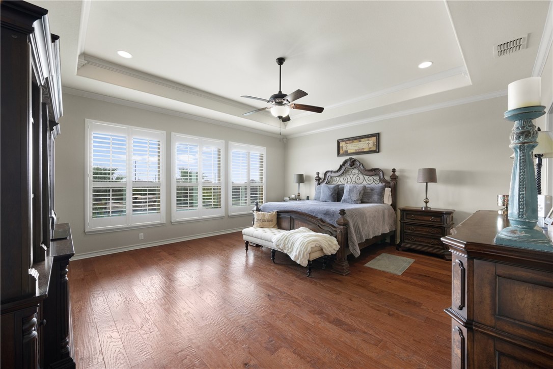 5310 Capernaum Court Corpus Christi, TX 78413 - Photo 15 of 40 a bedroom with a bed and wooden floor