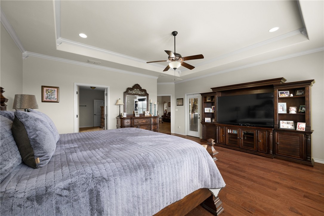 5310 Capernaum Court Corpus Christi, TX 78413 - Photo 16 of 40 a spacious bedroom with a bed and a flat screen tv