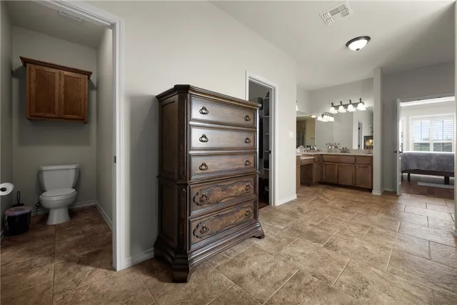 a view of a hallway with closet and cabinet