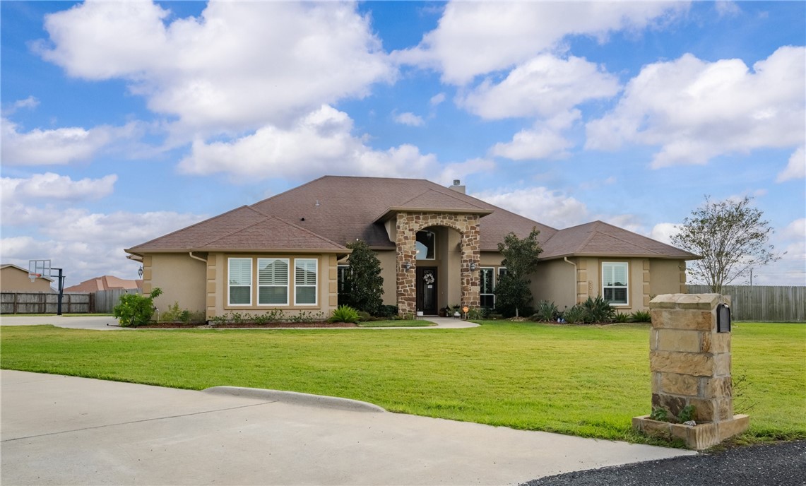 5310 Capernaum Court Corpus Christi, TX 78413 - Photo 2 of 40 a front view of a house with a garden