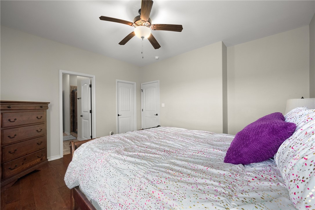 5310 Capernaum Court Corpus Christi, TX 78413 - Photo 22 of 40 a bedroom with a bed and a chandelier