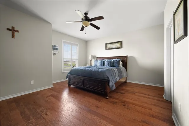 a bedroom with a bed and a ceiling fan