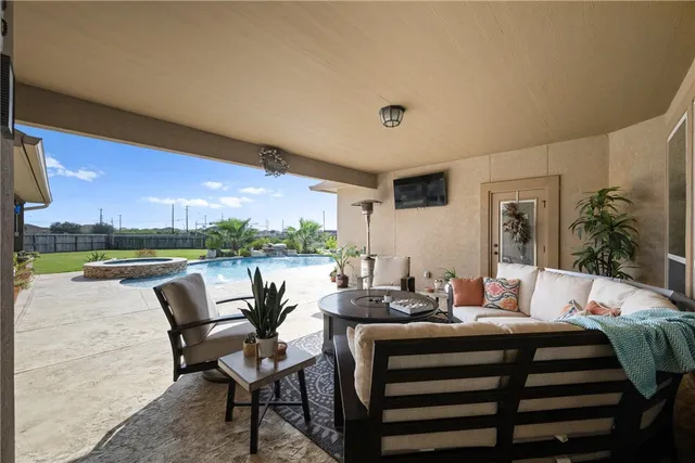 a dining room with furniture and a floor to ceiling window
