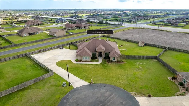 an aerial view of a house with outdoor space