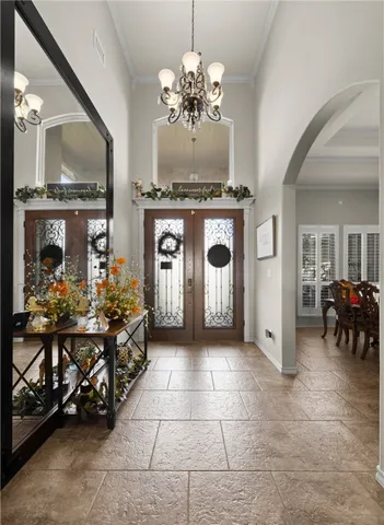 a living room with furniture and a chandelier