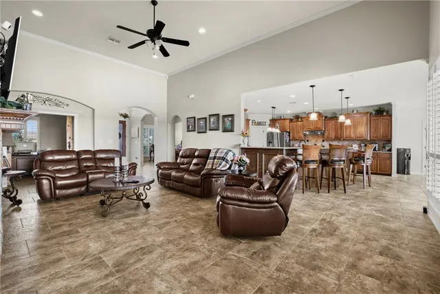 a living room with lots of furniture and a chandelier