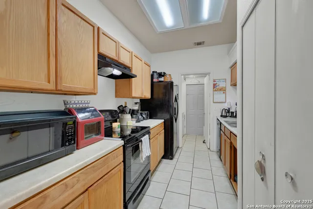 a kitchen with stainless steel appliances granite countertop a stove and a refrigerator