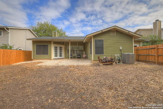 a backyard of a house with yard and trampoline