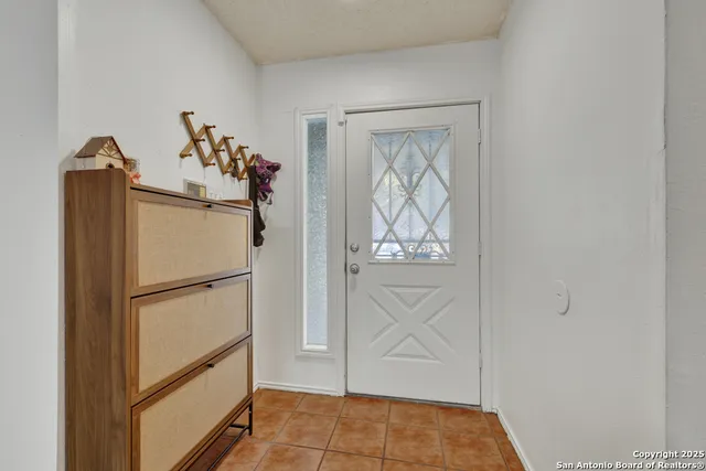 a white refrigerator freezer and a wooden floor