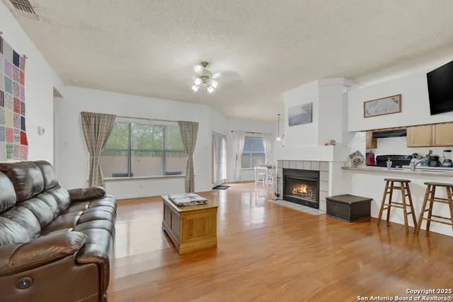 a living room with furniture fireplace and flat screen tv