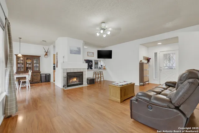 a living room with furniture a fireplace and a flat screen tv
