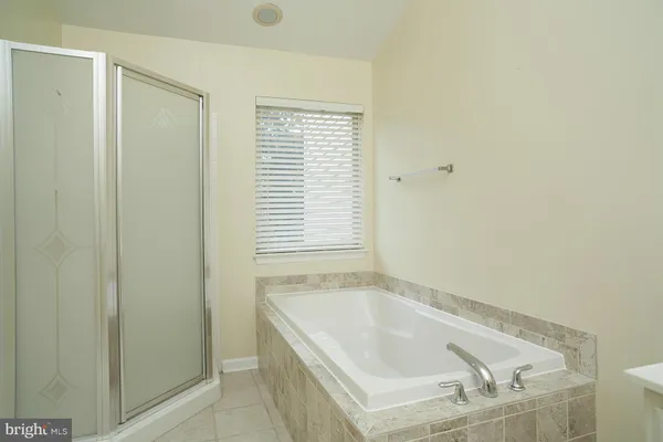 a bathroom with a tub and shower