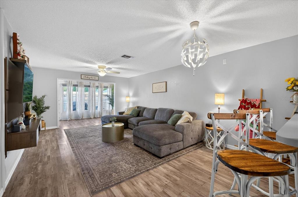 3230 Teeside Drive New Port Richey, FL 34655 - Photo 10 of 32 a living room with furniture and a chandelier