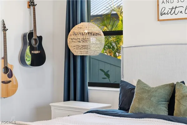 a bed room with a bed mirror and a window