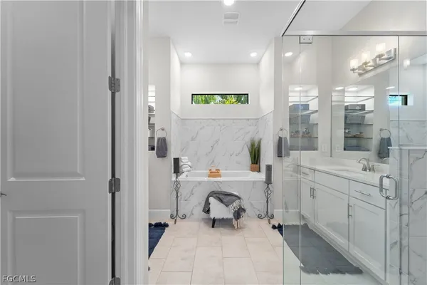 a bathroom with a sink a large mirror and shower