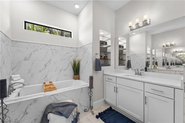 a bathroom with a double vanity sink mirror and shower