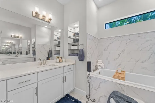 a spacious bathroom with a shower sink and a mirror