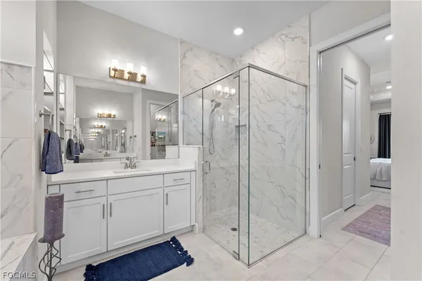 a living room with furniture and a view of kitchen