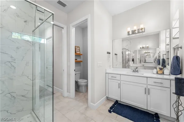 a bedroom with furniture and a flat screen tv