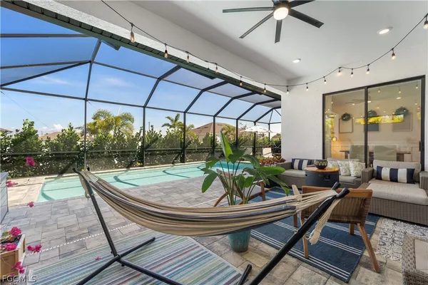 a outdoor living space with furniture and umbrella
