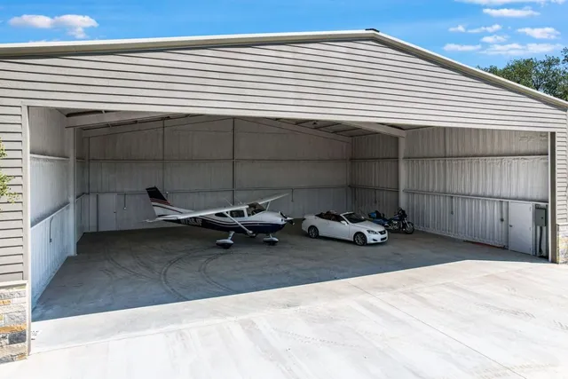 a view of a garage with parked cars