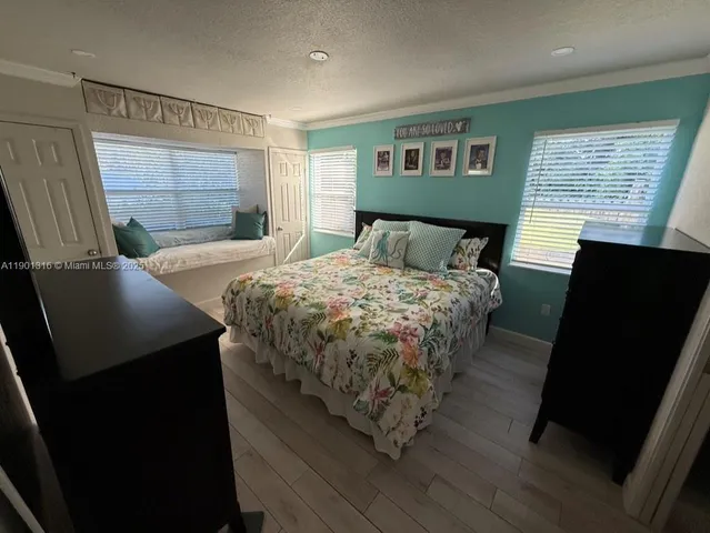 a bedroom with a bed and a television