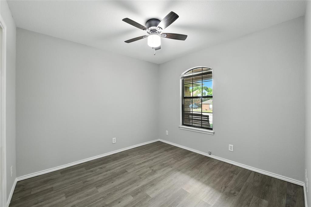 602 Valleyridge Court Decatur, TX 76234 - Photo 13 of 27 an empty room with chandelier fan and windows