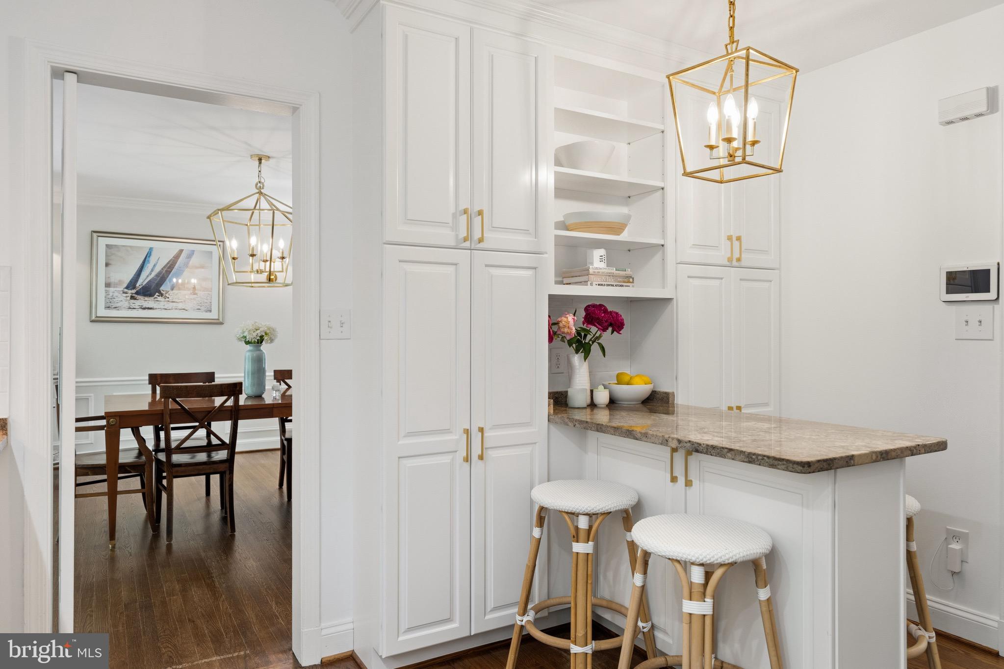 4555 W Street Northwest Washington, DC 20007 - Photo 6 of 34 a view of dining room and kitchen with furniture wooden floor and a chandelier