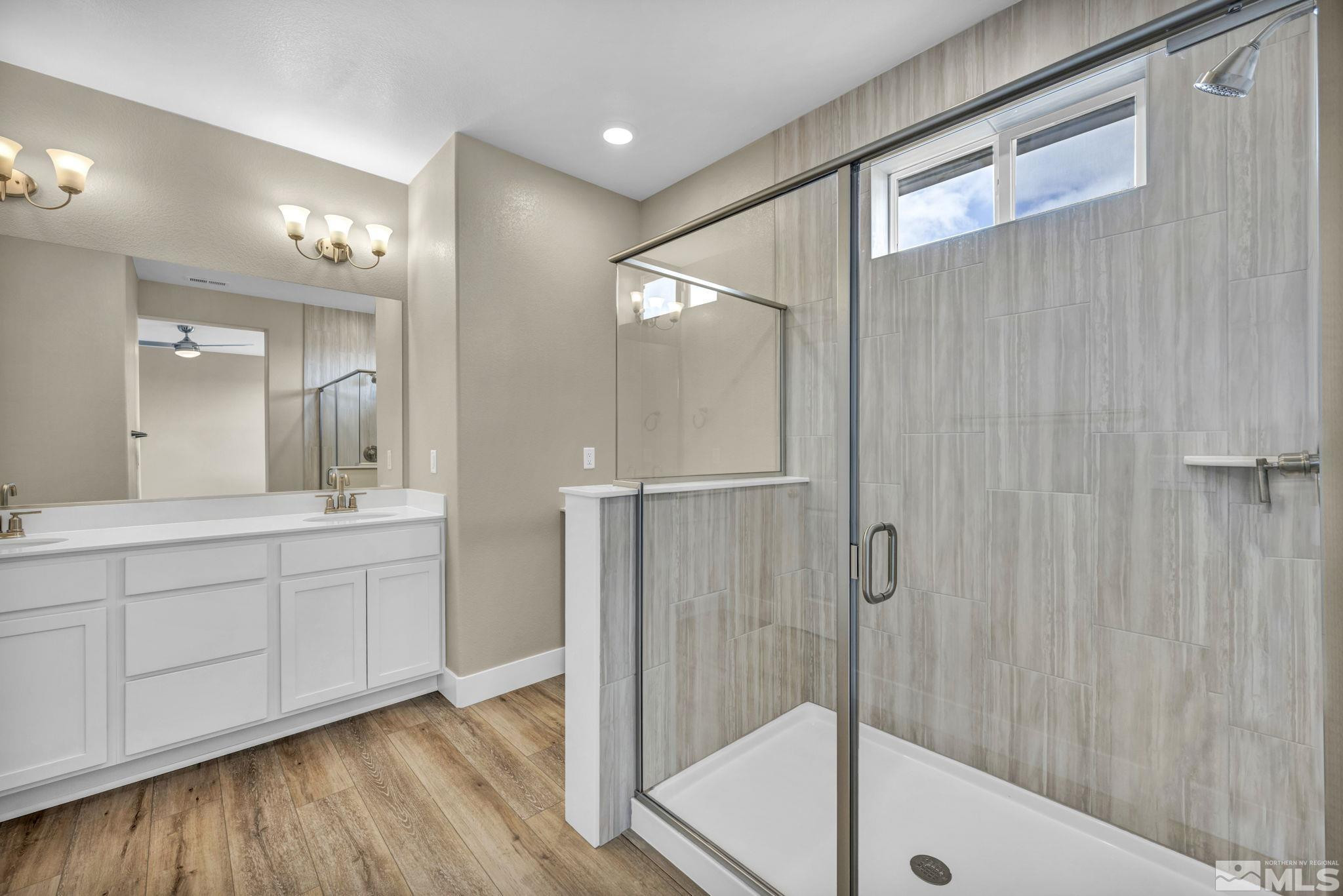 3660 Flare Lane, Unit 22 Carson City, NV 89705 - Photo 11 of 22 a large bathroom with a glass shower door and a sink
