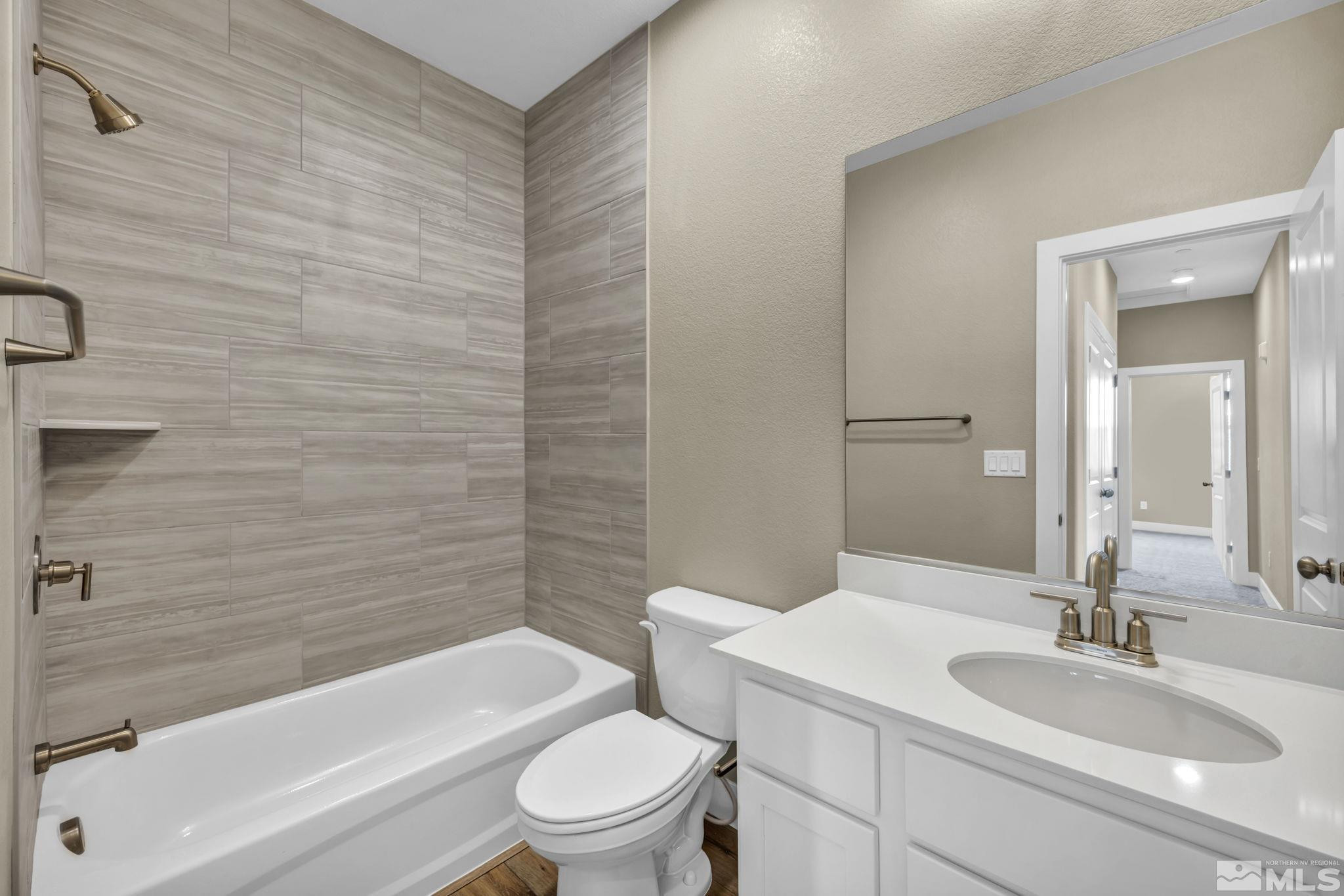 3660 Flare Lane, Unit 22 Carson City, NV 89705 - Photo 16 of 22 a bathroom with a granite countertop toilet a sink and a bathtub