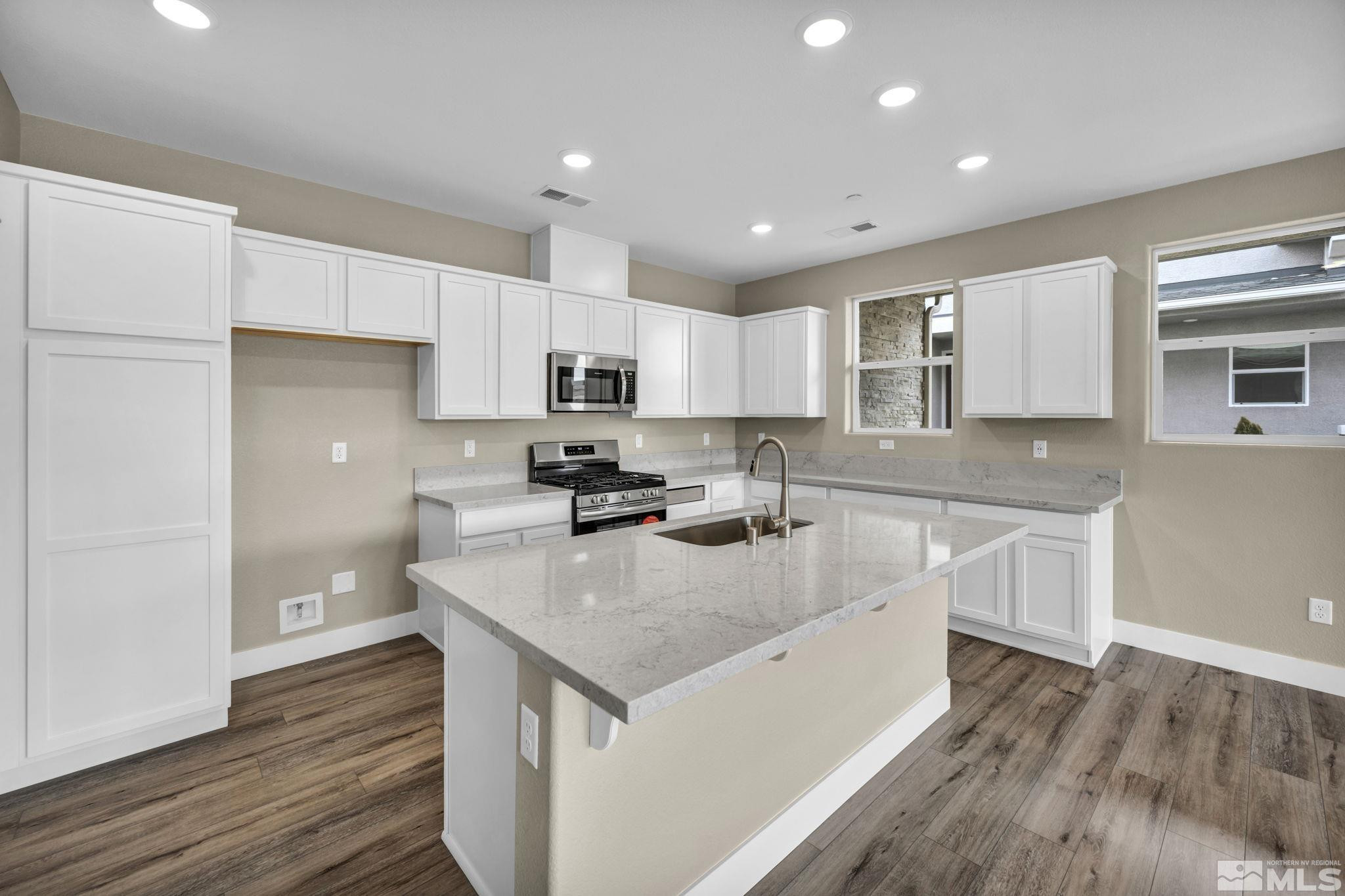3660 Flare Lane, Unit 22 Carson City, NV 89705 - Photo 4 of 22 a kitchen with a sink a stove a refrigerator a center island and cabinets