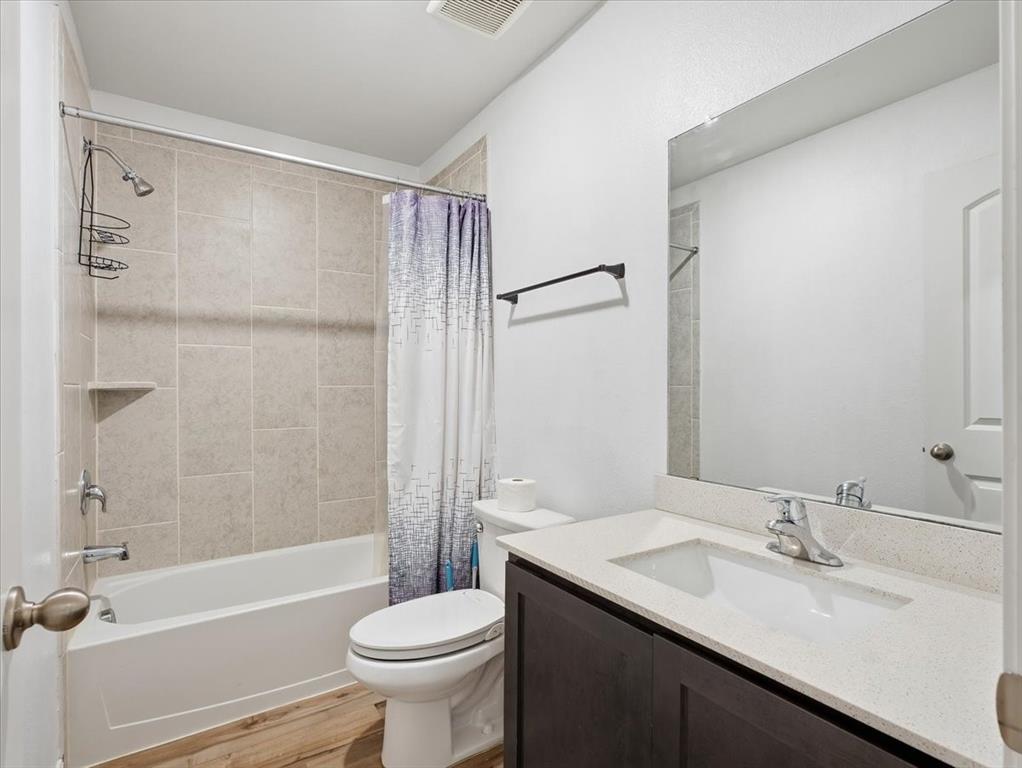 3083 Chillingham Drive Forney, TX 75126 - Photo 15 of 20 a bathroom with a sink a toilet and a bathtub