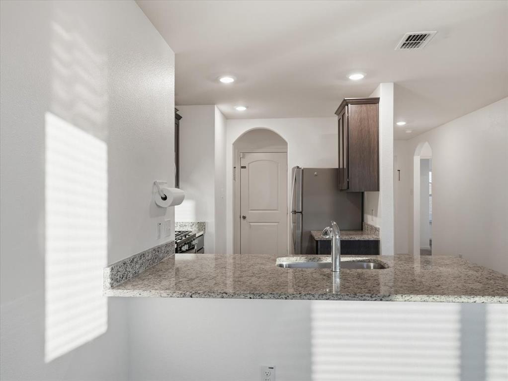 3083 Chillingham Drive Forney, TX 75126 - Photo 5 of 20 a bathroom with a granite countertop sink and a mirror