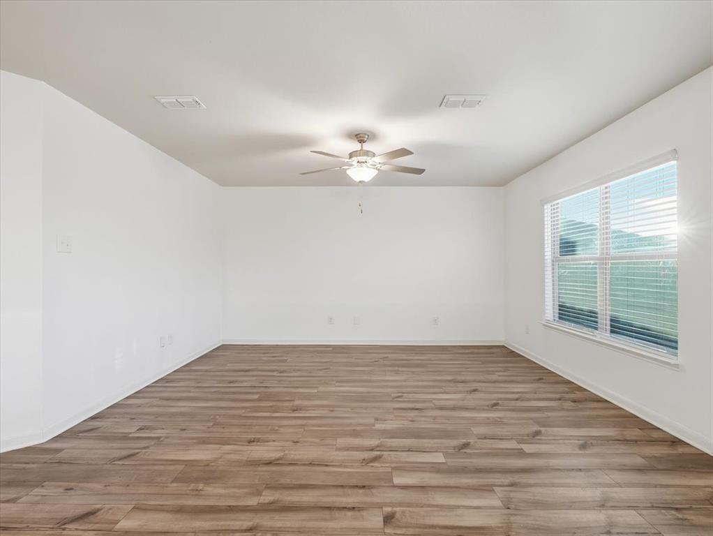 3083 Chillingham Drive Forney, TX 75126 - Photo 8 of 20 wooden floor in an empty room with a window