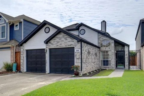 a living room with furniture a fireplace and a chandelier