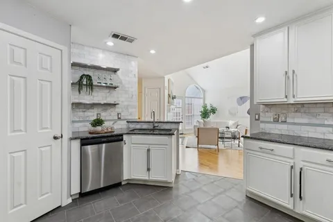 a kitchen with stainless steel appliances granite countertop a stove and a sink