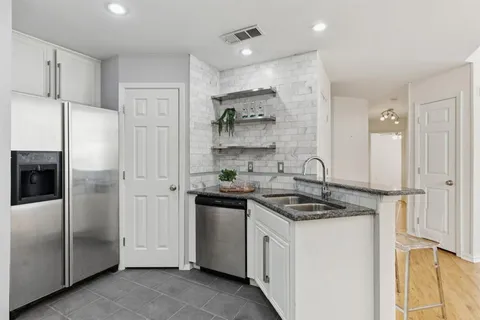 a spacious bedroom with a bed couch and window