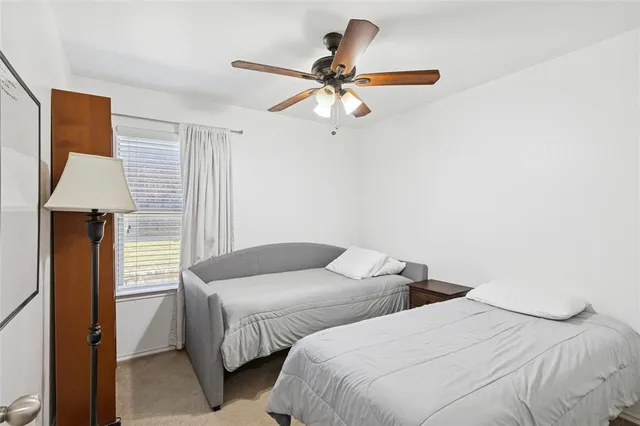 a bedroom with two beds and painted walls