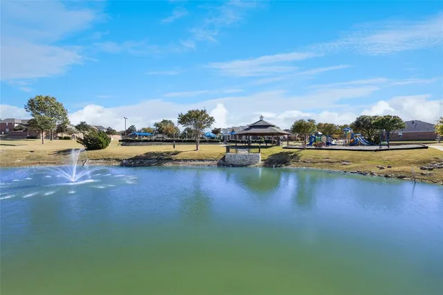 a view of a lake with houses in the back