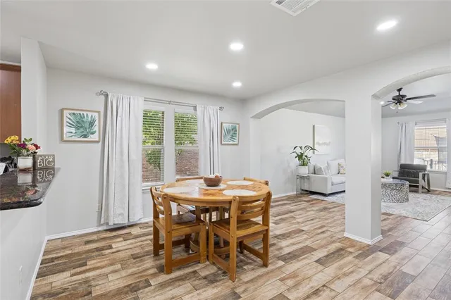 a view of a dining room with furniture and wooden floor