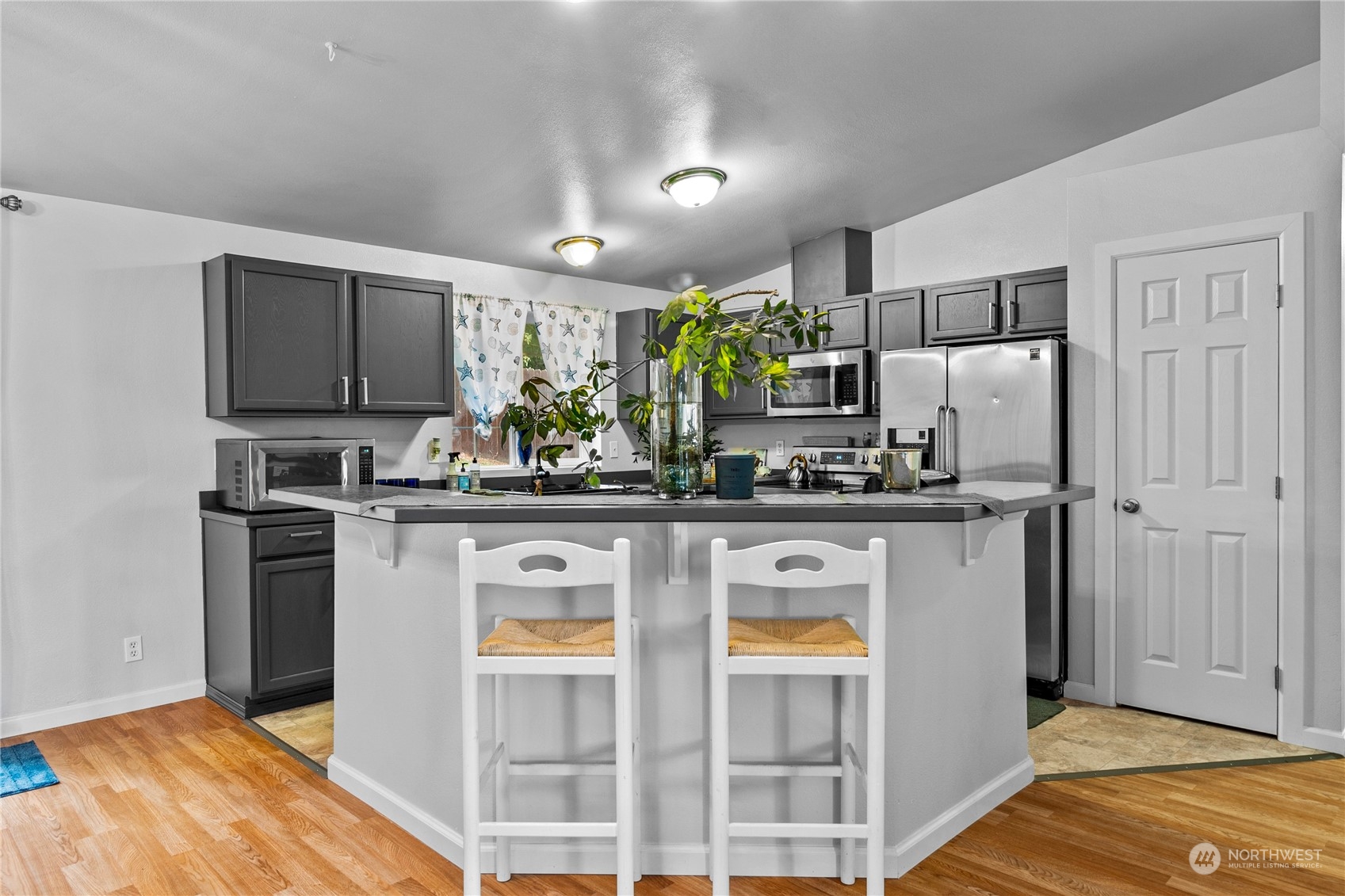 192 Gold Creek Road Northwest Bremerton, WA 98312 - Photo 16 of 38 a kitchen with stainless steel appliances a refrigerator sink and microwave