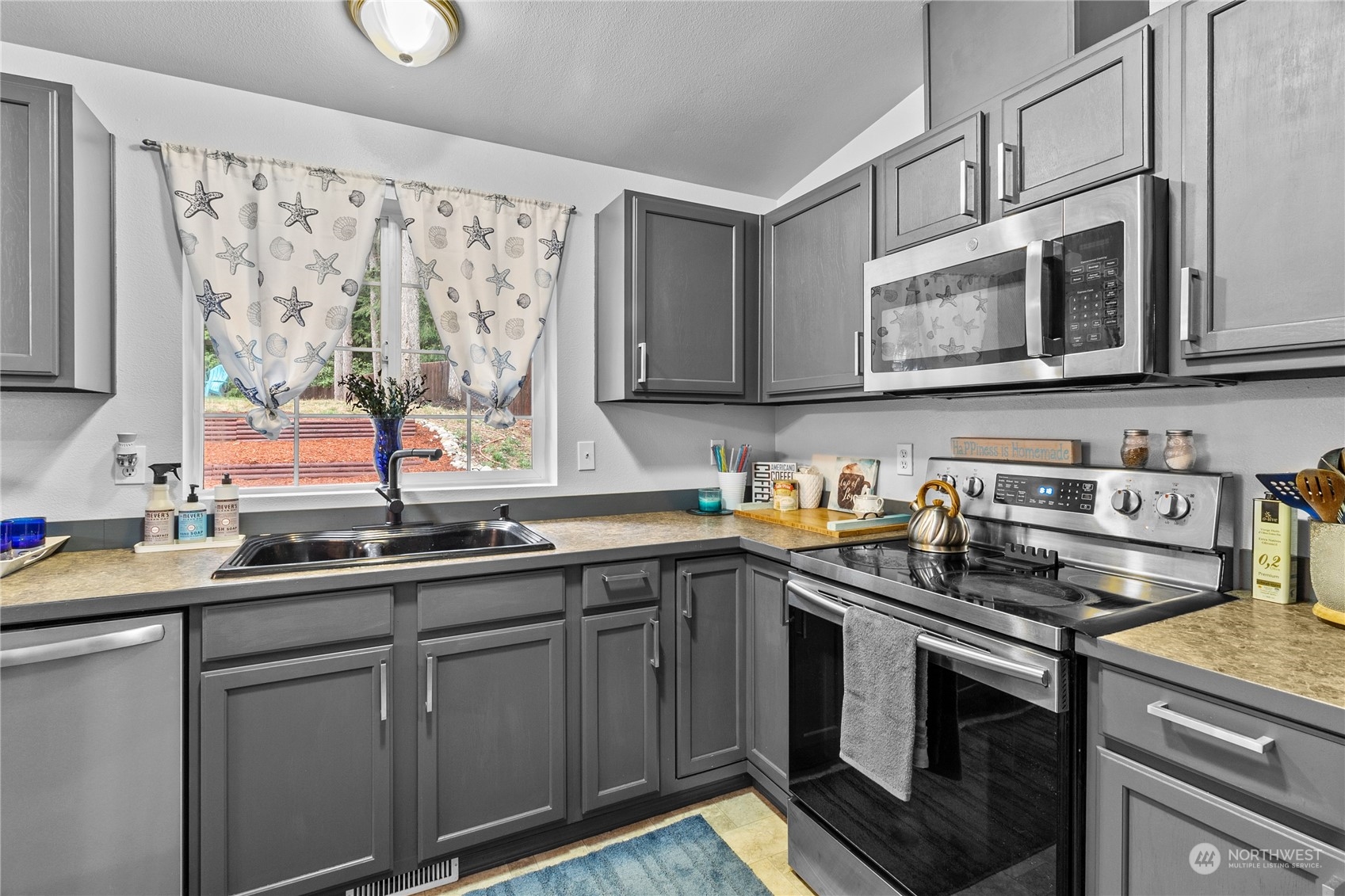 192 Gold Creek Road Northwest Bremerton, WA 98312 - Photo 17 of 38 a kitchen with stainless steel appliances a sink stove and cabinets