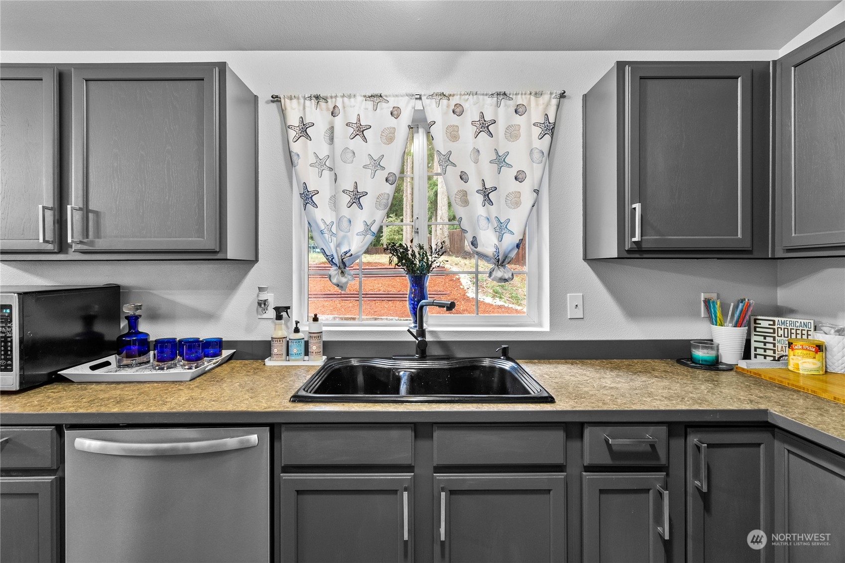 192 Gold Creek Road Northwest Bremerton, WA 98312 - Photo 18 of 38 a kitchen with a sink cabinets and window