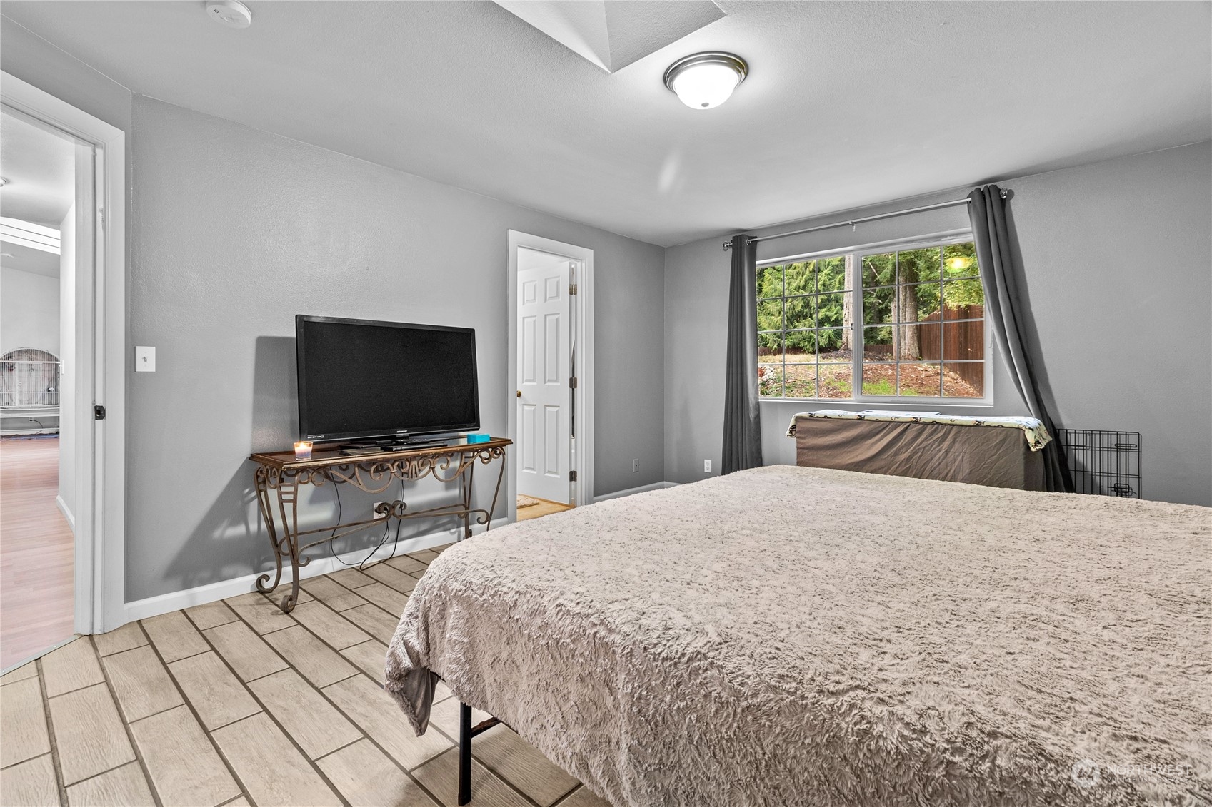 192 Gold Creek Road Northwest Bremerton, WA 98312 - Photo 21 of 38 a bedroom with a bed and a flat screen tv