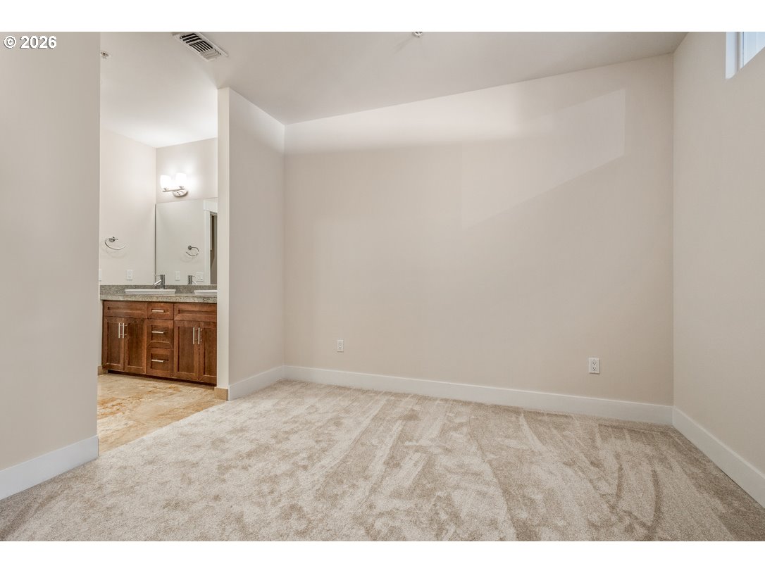 838 Southeast 38th Avenue, Unit 202 Portland, OR 97214 - Photo 19 of 34 a spacious bathroom with a sink and a mirror