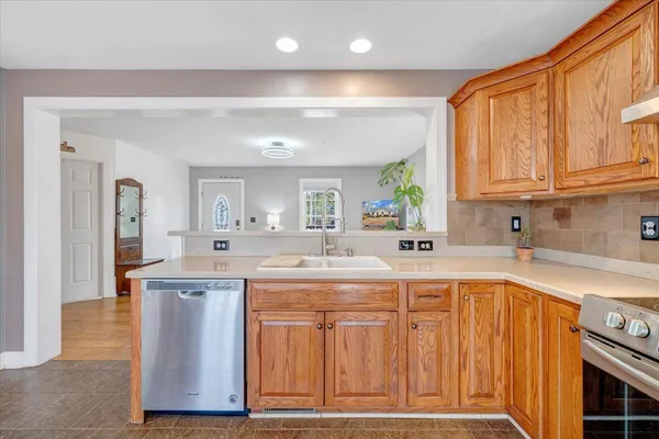 a kitchen with a sink cabinets and window