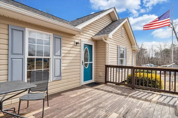 a view of a balcony with wooden floor and fence