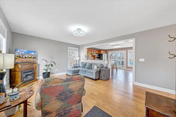 a living room with fireplace furniture and flat screen tv
